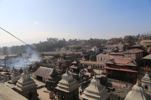 The Pashupati temple complex with the burning cremation ghats on the left